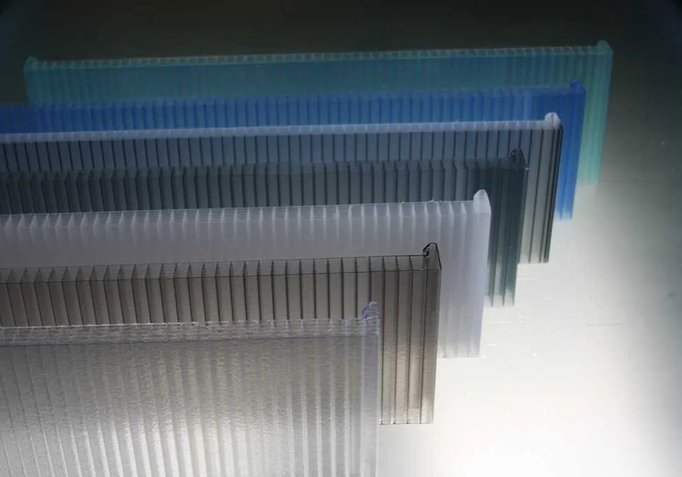 Cellular polycarbonate sheet edges showing the hollow multiwall cell structure, in several tints