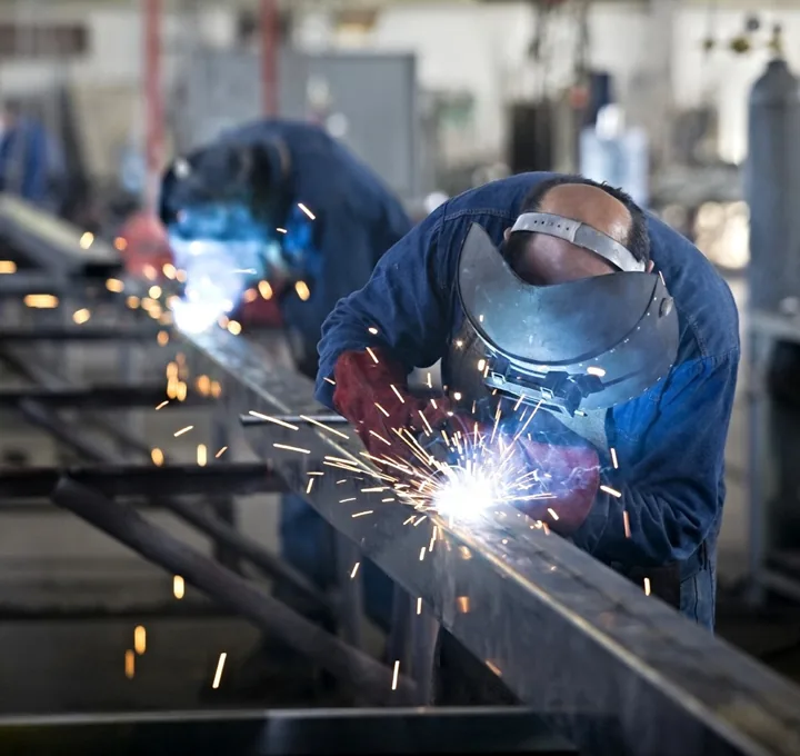 Welders fabricating structural steel canopy framing in the Duo-Gard shop